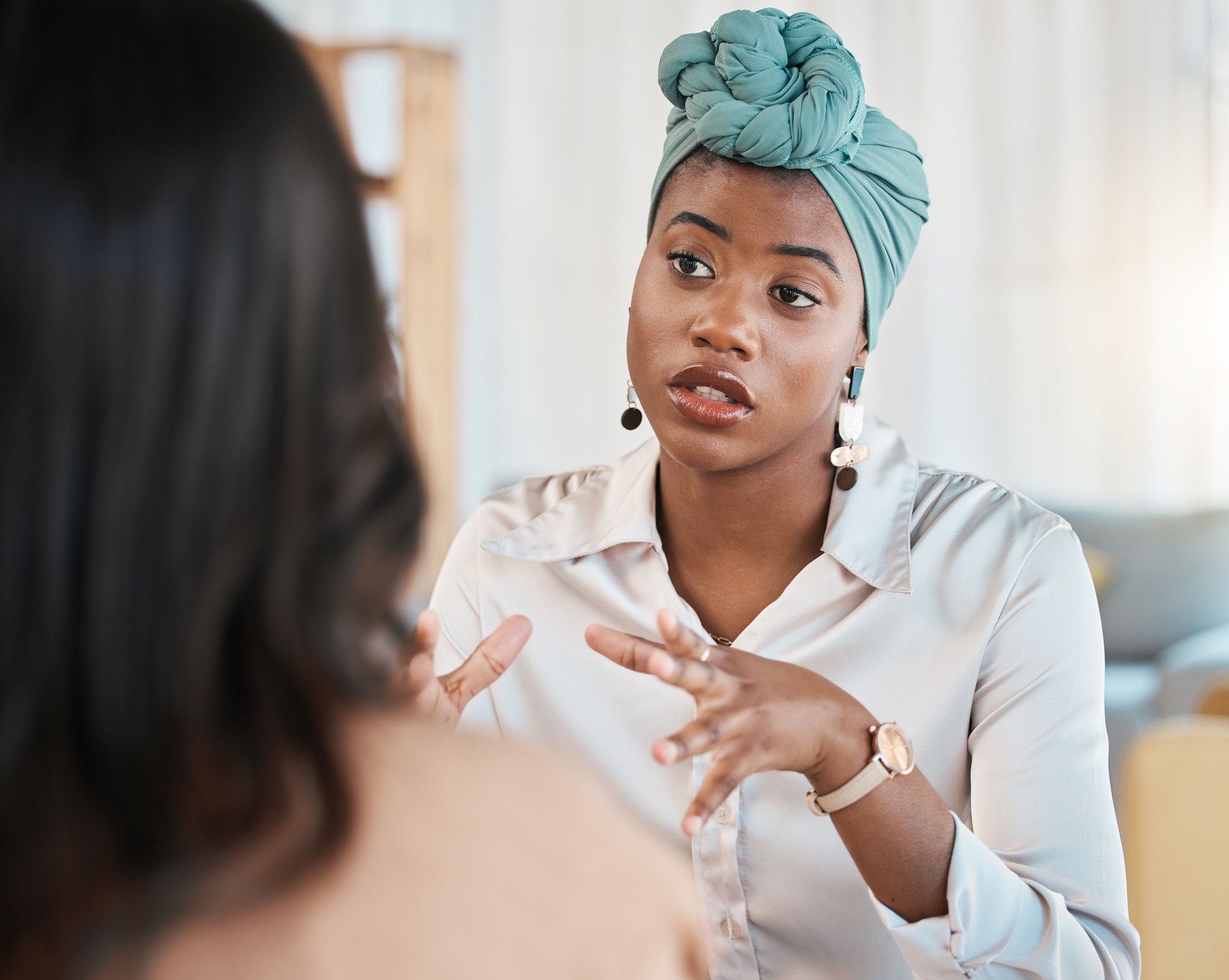 Conversation, business people and meeting or interview in office with a black woman as leader. A serious African female entrepreneur with employee talking for advice, idea or communication at work