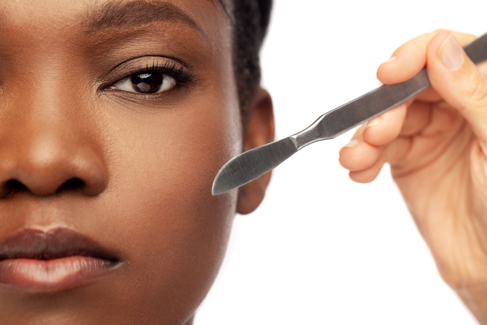 face of african american woman and scalpel knife