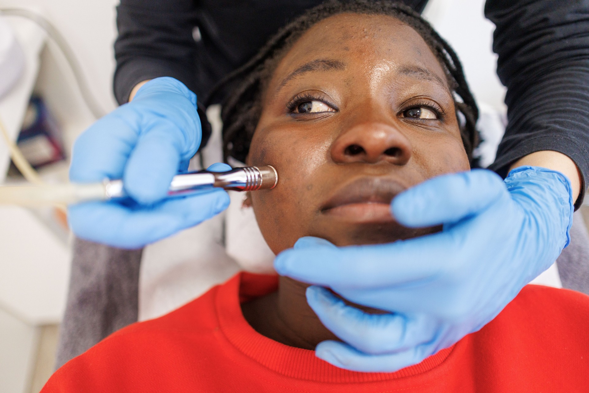 Aesthetician Performing Non-Invasive Microdermabrasion Facial on Female Client