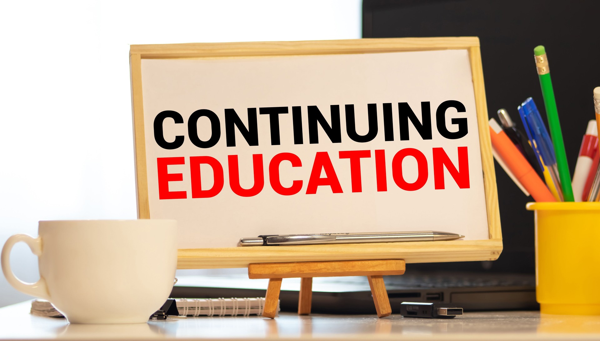 Continuing education written on classroom blackboard